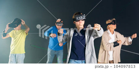Young boy and girl playing VR games with grandparents 104097813