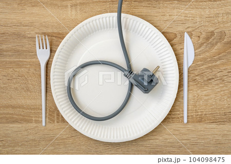 Electric plug as concept of energy on the plate Electric plug as concept of energy on the plate 104098475