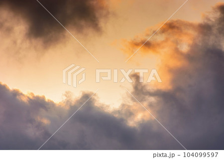 evening sky in orange glow. huge fluffy clouds. dramatic natural background 104099597