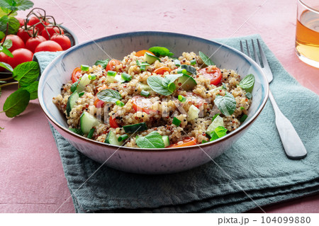 Quinoa tabbouleh salad in a bowl, a healthy dinner with tomatoes and mint Quinoa tabbouleh salad in a bowl, a healthy dinner with tomatoes and mint 104099880