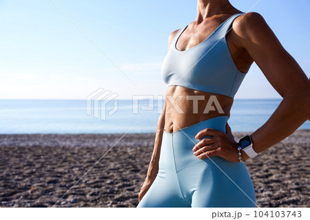 Close up photo. Abs. Beautiful sexy girl with muscular body posing. Fitness concept 104103743