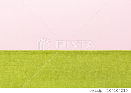 top view with green kitchen napkin isolated on table background. Folded cloth for mockup with copy space, Flat lay. Minimal style top view with green kitchen napkin isolated on table background. Folded cloth for mockup with copy space, Flat lay. Minimal style 104104259