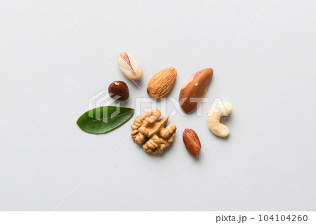 Composition of nuts , flat lay - mix hazelnuts, cashews, almonds on table background. healthy eating concepts and food background 104104260