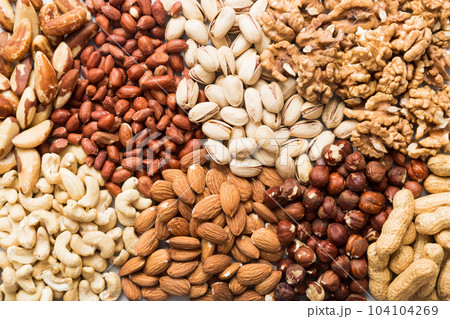 different nuts background. Close up, top view, flat lay. Walnut, pistachios, almonds, hazelnuts and cashews 104104269