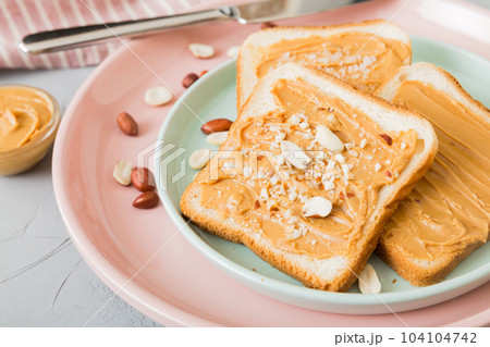 Peanut butter sandwiches or toasts on light table background.Breakfast. Vegetarian food. American cuisine top view vith copy space Peanut butter sandwiches or toasts on light table background.Breakfast. Vegetarian food. American cuisine top view vith copy space 104104742