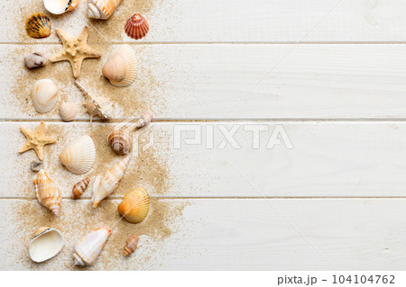 Summer time concept Flat lay composition with beautiful starfish and sea shells on colored table, top view with copy space for text Summer time concept Flat lay composition with beautiful starfish and sea shells on colored table, top view with copy space for text 104104762