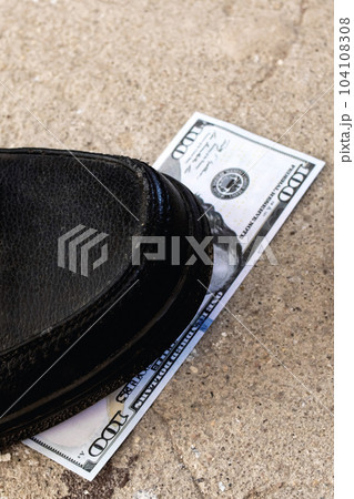 One hundred dollar bill under the shoe One hundred dollar bill under the shoe 104108308