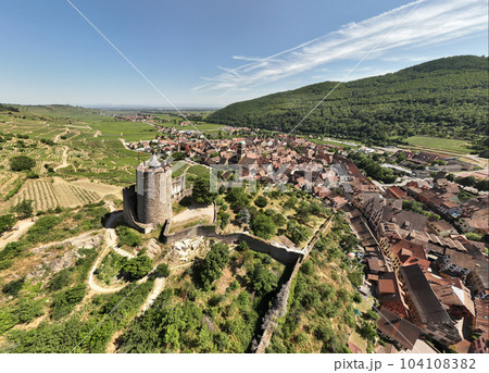 Aerial Drone Shot of the village of Kaysersberg in Alsace in a day. Summer in France, Castle and a beautiful City Aerial Drone Shot of the village of Kaysersberg in Alsace in a day. Summer in France, Castle and a beautiful City 104108382