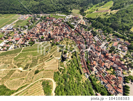 Aerial Drone Shot of the village of Kaysersberg in Alsace in a day. Summer in France, Castle and a beautiful City Aerial Drone Shot of the village of Kaysersberg in Alsace in a day. Summer in France, Castle and a beautiful City 104108383