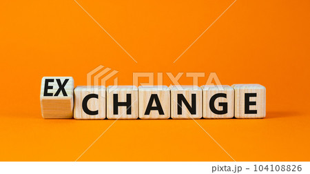 Change or exchange symbol. Turned wooden cubes and changed the concept word Change to Exchange. Beautiful orange table orange background. Copy space. Business and change or exchange concept. 104108826