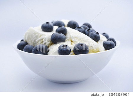 Ice cream with berries. Ice cream in a ceramic bowl. Ice cream and blueberries. 104108904