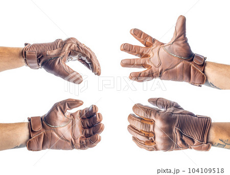Vintage leather motorcycle gloves on hand isolated on white background. Vintage leather motorcycle gloves on hand isolated on white background. 104109518