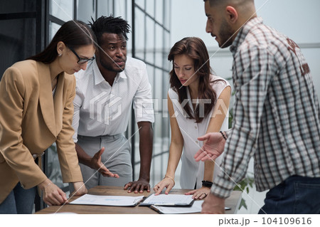 Ambitious smart employee speaks in a meeting and shares her opinion on a creative idea in a group briefing 104109616
