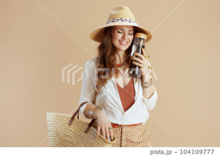 smiling trendy woman in blouse and shorts against beige smiling trendy woman in blouse and shorts against beige 104109777