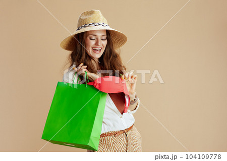 smiling elegant woman in blouse and shorts on beige smiling elegant woman in blouse and shorts on beige 104109778