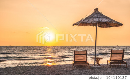 Sunshade beach umbrellas with sunset sky and sea background. Sarande, Albania Sunshade beach umbrellas with sunset sky and sea background. Sarande, Albania 104110127