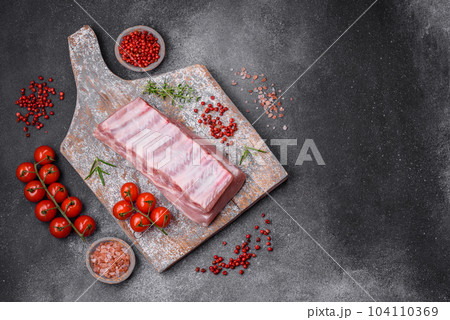 Raw pork ribs with meat with salt, spices and herbs 104110369