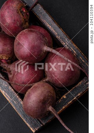 Fresh raw beetroot in the form of tubers on a textured concrete background 104110394