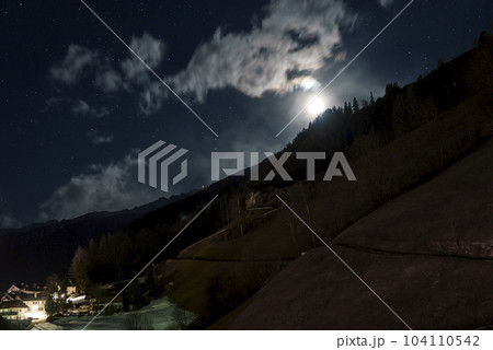 Scenic view of stars glowing over mountain and landscape at night 104110542