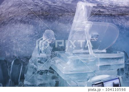 Beautiful ice statue of man playing piano in glacier tunnel at ice palace in Jungfrau, Switzerland, winter holiday travel concept 104110598