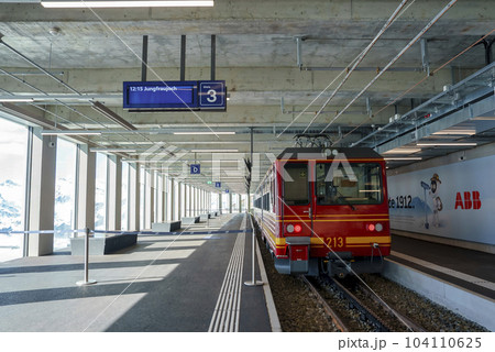 Red electric train parked at empty Jungfrau railway station in Switzerland, winter holiday concept for tourists Red electric train parked at empty Jungfrau railway station in Switzerland, winter holiday concept for tourists 104110625