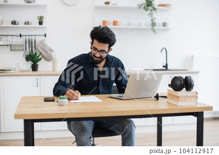 Business owner correcting text using computer at home Business owner correcting text using computer at home 104112917