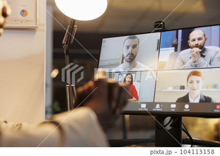 Team discussing business ideas during online videocall meeting conference, working over hours at marketing report, planning investment strategy in startup office. Remote discussion concept Team discussing business ideas during online videocall meeting conference, working over hours at marketing report, planning investment strategy in startup office. Remote discussion concept 104113158