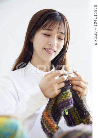 リビングにて趣味の手芸で毛糸を編む30代の日本人女性 104115858
