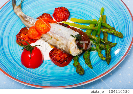 Baked poutassou with dried tomatoes, asparagus and creamy garlic sauce Baked poutassou with dried tomatoes, asparagus and creamy garlic sauce 104116586