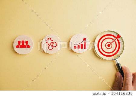 Target icon under magnifying glass, reflecting the essence of start-ups, creative ideas, and innovation. It symbolizes motivation, planning, development, and leadership for customer targeting. Target icon under magnifying glass, reflecting the essence of start-ups, creative ideas, and innovation. It symbolizes motivation, planning, development, and leadership for customer targeting. 104116839