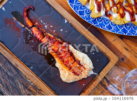 Ggrilled octopus tentacle with potato parmentier 104116976