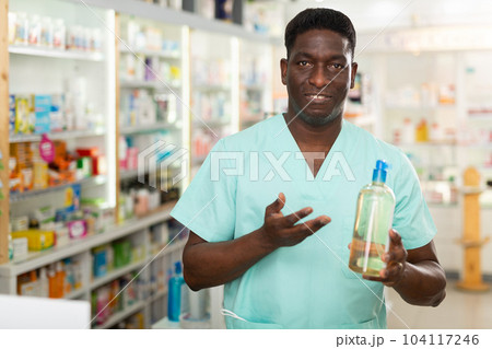 Pharmacist demonstrating haircare product 104117246