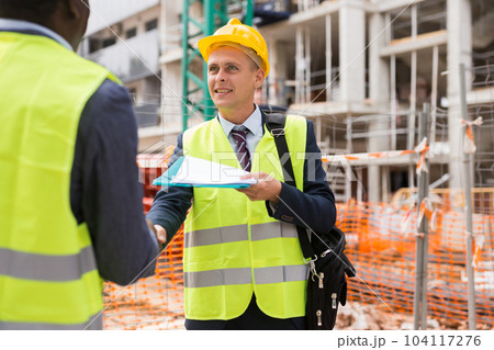 Two confident civil engineers exchange a friendly handshake 104117276