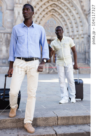 African-american tourists taking walk in the town with the travel bag 104117327