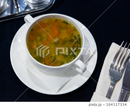 Hearty vegetable soup with fresh chopped dill 104117334