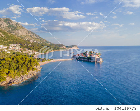 Aerophotography. Aerial view of Sveti Stefan island in a beautiful summer day, Montenegro from flying drone. Panoramic above view of Saint Stephen luxury resort. Tourism and leisure concept 104119778