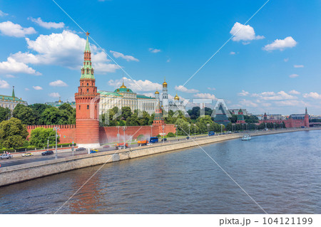 View of Kremlin with Vodovzvodnaya tower, Grand Kremlin Palace from repaired Bolshoy Kamenny Bridgein Moscow city on sunny summer day View of Kremlin with Vodovzvodnaya tower, Grand Kremlin Palace from repaired Bolshoy Kamenny Bridgein Moscow city on sunny summer day 104121199
