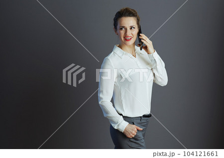 happy business owner woman talking on phone and looking aside 104121661