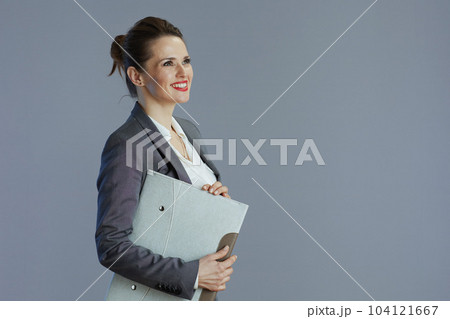 smiling trendy 40 years old woman worker isolated on gray smiling trendy 40 years old woman worker isolated on gray 104121667