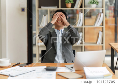 Financier a asian man feel stress with works, uses a laptop, makes a report to a finance company. Accounting and financial concept Financier a asian man feel stress with works, uses a laptop, makes a report to a finance company. Accounting and financial concept 104121705