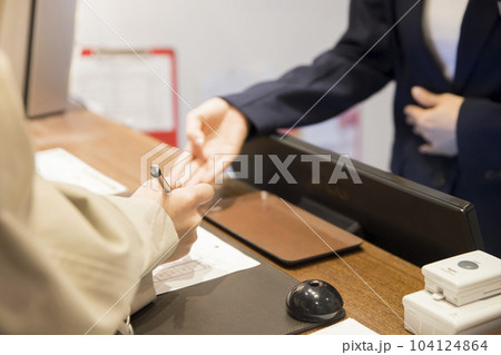 ホテルチェックイン手続きをする若い女性手元 ホテルチェックイン手続きをする若い女性手元 104124864
