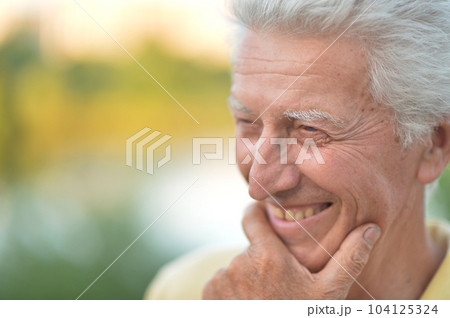 Elderly or senior man close up portrait. Happy and smiling. 104125324