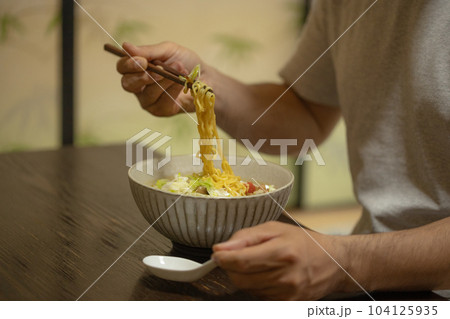 インスタントラーメンを一人で食べる寂しい男性 インスタントラーメンを一人で食べる寂しい男性 104125935