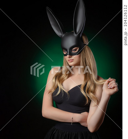 girl in a rabbit mask with beautiful eyes on a dark background girl in a rabbit mask with beautiful eyes on a dark background 104126112