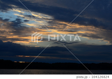 Beautiful sunset reflected in the lake Beautiful sunset reflected in the lake 104126824