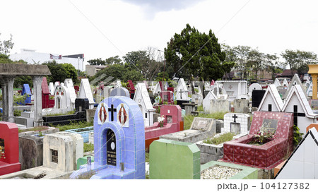 Public cemetery with varied graves. 104127382