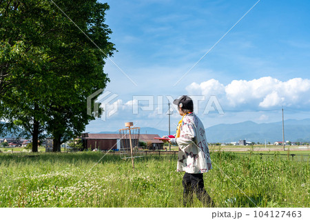 滋賀県　琵琶湖のほとりにある奥びわスポーツの森でバスケットに向けてディスクゴルフを楽しむ年配の女性 104127463