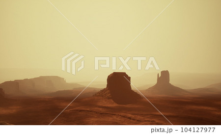 Sunset at the sisters in Monument Valley 104127977