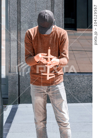A street performer moving twine with his hands to manipulate an object in a puppet theater. The concept of domination and control A street performer moving twine with his hands to manipulate an object in a puppet theater. The concept of domination and control 104129567