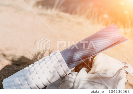Woman summer travel sea. Happy tourist in hat enjoy taking picture outdoors for memories. Woman traveler posing on the beach at sea surrounded by volcanic mountains, sharing travel adventure journey 104130368